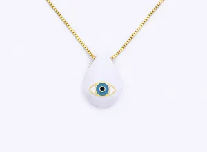 Detail view of gold-plated box chain necklace with a white teardrop evil eye pendant.