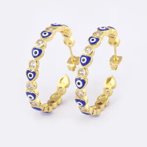 Gold plated evil eye hoop earrings with heart-shaped blue enamel and sparkling cubic zirconia.