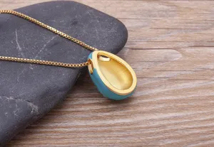 Gold-plated teardrop enamel evil eye pendant necklace detail shot for daily fashion wear.