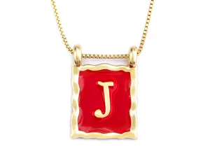 Detailed close-up of the retro 18k gold plated square letter J pendant with red enamel.