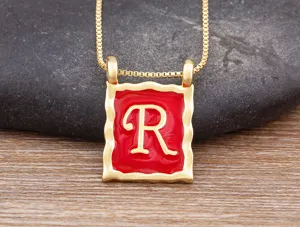 Gold-plated square letter R pendant necklace detail view, red enamel niche design clavicle chain.