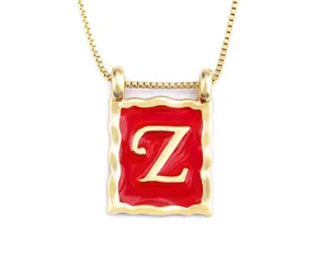 Gold plated 18k copper initial necklace with red enamel rectangular pendant and box chain.