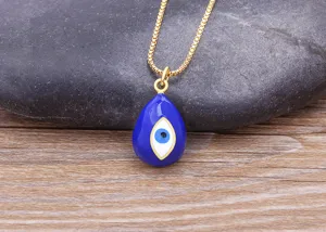 Detailed close-up of a stunning gold plated evil eye pendant necklace with blue enamel.