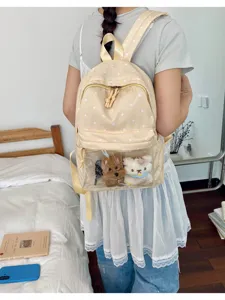 Women stylish polka dot casual backpack with transparent front pocket and cute plush toys.