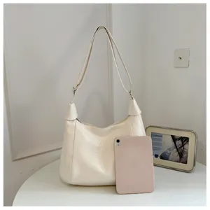 Minimalist off-white leather shoulder bag with adjustable strap for women casual daily wear.