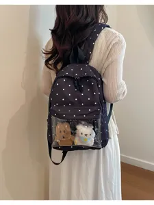 Detail shot of the stylish polka dot backpack with transparent front pocket display cute toys.