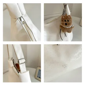 Stylish white faux leather shoulder bag with chic cross pattern and cute dog plush pendant.