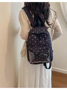 Chic black polka dot backpack with clear front pocket, sweet style for casual daily wear.