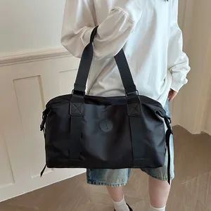 Detail view of a lightweight black travel duffel bag, large capacity canvas gym and sports bag.
