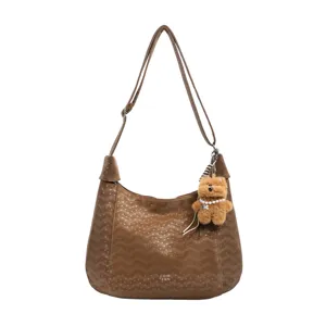 Casual minimalist brown shoulder crossbody bag for women with cute bear pendant charm.