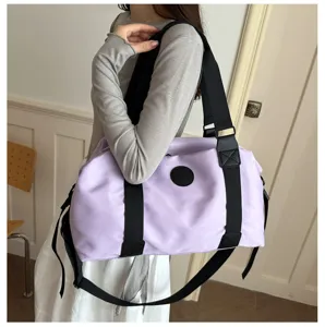 Lightweight purple travel duffel bag with black straps, large capacity for sports and gym.