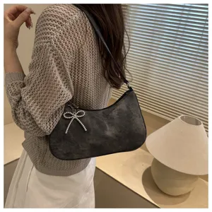 Elegant dark gray shoulder underarm bag featuring a sparkly rhinestone bow charm detail.
