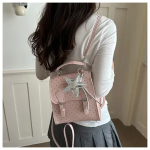 Pink polka dot mini backpack detail, stylish women school bag with cute star pendant decoration.