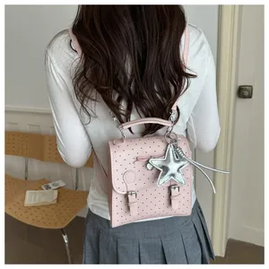 Detail view of the stylish pink mini backpack with star pendant, casual lifestyle daily use bag.