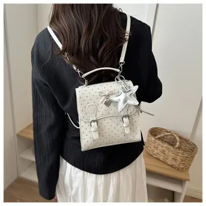 Detailed back view of a stylish white polka dot women backpack with cute star and heart charms.
