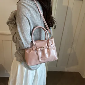 Pink patent leather shoulder handbag for women, vintage minimalist design crossbody tote bag.