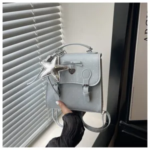 Light blue polka dot mini backpack for women, sweet style small school bag with star pendant.