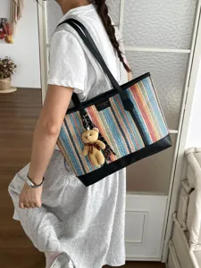 Stylish woven tote bag with colorful stripes and black leather trim for women daily commuting.