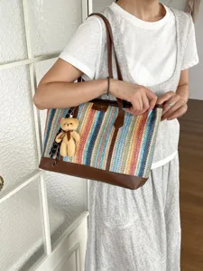 Detailed view of the colorful woven tote bag, featuring leather trim and cute bear charm.