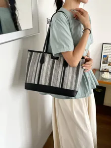 Stylish woven tote bag for women, large capacity casual shoulder bag with classic striped design.