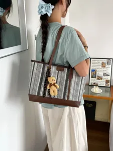 Woven tote bag for women, large capacity casual shoulder bag with cute bear pendant.