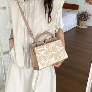 Minimalist commuter shoulder bag for women, stylish top handle design with elegant V clasp.