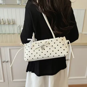 Chic polka dot underarm shoulder bag for women, stylish bowknot commute handbag with heart charm.