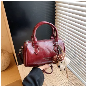 Vintage dark red barrel handbag PU leather pillow shoulder bag with cute puppy pendant detail