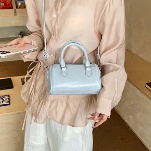 Classic barrel shoulder bag for women, vintage solid color crossbody bag with top handle.
