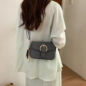 Stylish textured minimalist shoulder bag for women, chic crossbody bag with metal buckle.