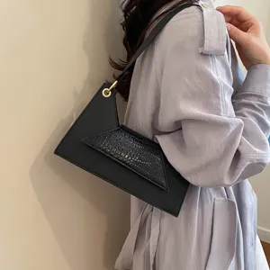 Women's minimalist asymmetric shoulder bag, chic niche design, stylish commuting handbag.