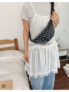 Casual black polka dot crossbody chest bag for women, stylish commuter fanny pack daily wear.