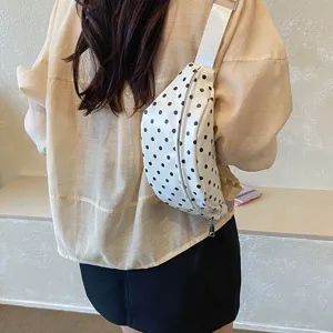 Stylish white polka dot waist bag worn as a chest crossbody bag for casual daily outings.