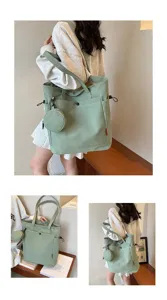 Detailed view of the light green canvas tote bag featuring a cute matching coin purse.