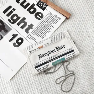 Sac bandoulière enveloppe en cuir PU avec imprimé journal créatif et chaîne en métal.