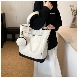 Large capacity color block canvas tote bag with detachable coin purse and exterior pockets.