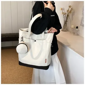 Detailed view of large capacity canvas tote bag in black and white with mini coin pouch.