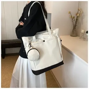 Large capacity canvas tote bag with contrast black bottom and mini coin pouch accessory.