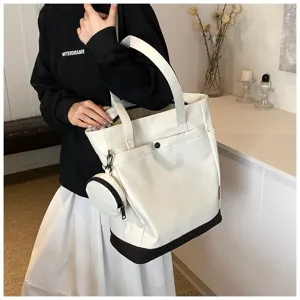 Detail view of the large capacity canvas tote bag with removable coin purse, worn by model.