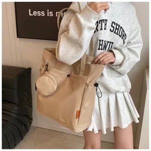 Stylish large capacity beige tote bag with a small coin purse for women daily use.