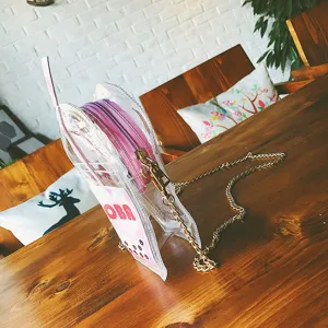 Transparente Jelly Umhängetasche in Flaschenform mit rosa Reißverschluss und goldener Kette.