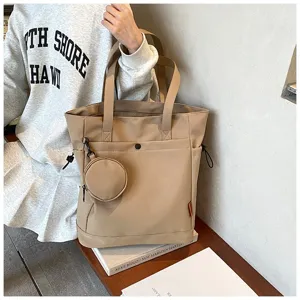Detailed view of the stylish beige tote bag with a small coin purse in daily use scene.