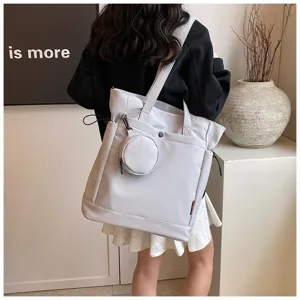Minimalist grey tote bag with round coin purse, spacious shoulder bag for women daily use.