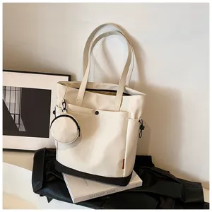 Details of the large capacity white canvas tote bag with stylish coin pouch and contrast bottom.