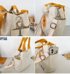 Canvas Beutel für Damen, süßes Smiley-Gesicht, gelbe Griffe und verstellbarer Schultergurt.