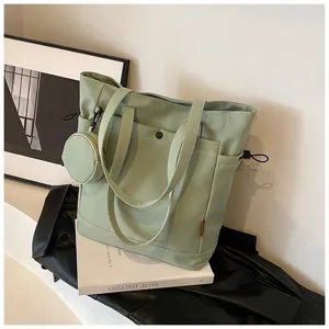 Light green canvas tote bag detail featuring dual handles, side pocket and small purse.