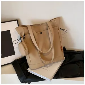 Detailed view of the large capacity beige canvas tote bag with a small coin purse and straps.