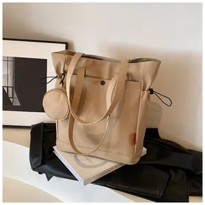 Detailed view of the beige tote bag featuring a front pocket and cute attached coin pouch.