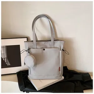 Detailed view of large capacity grey tote bag with coin purse and shoulder straps for daily use.
