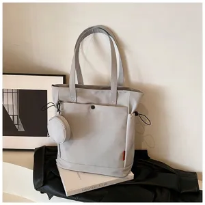 Large capacity casual tote bag detail showing grey fabric, shoulder straps and cute coin pouch.